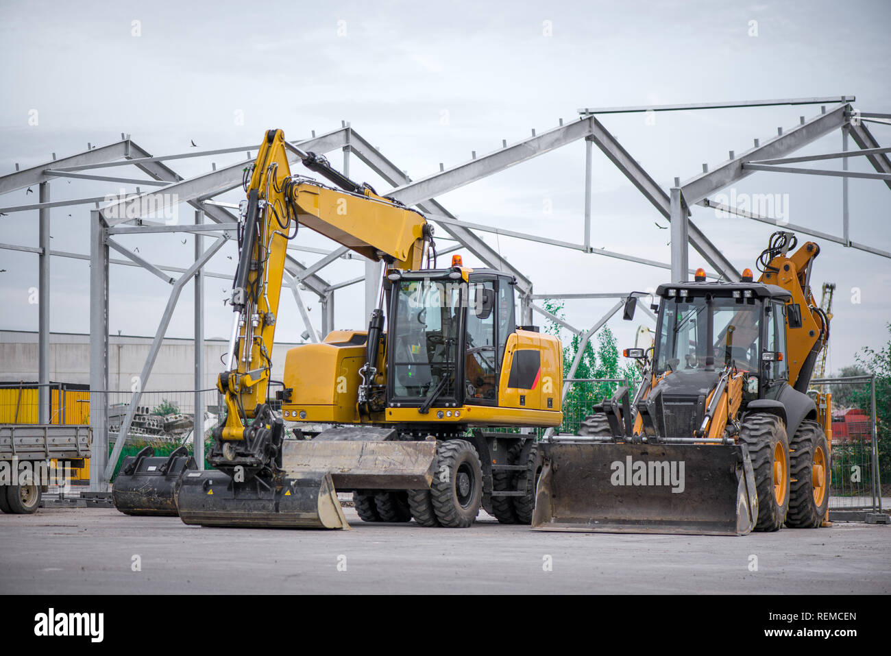 Multiple cars, excavators, trucks, loaders, concrete mixers and