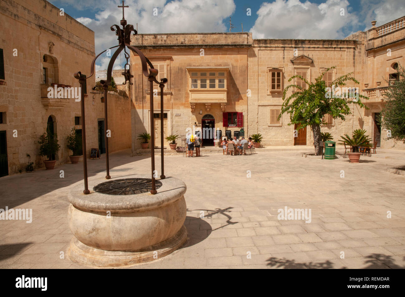 A group of tourists visiting an outdoor café in Mesquita Square in the