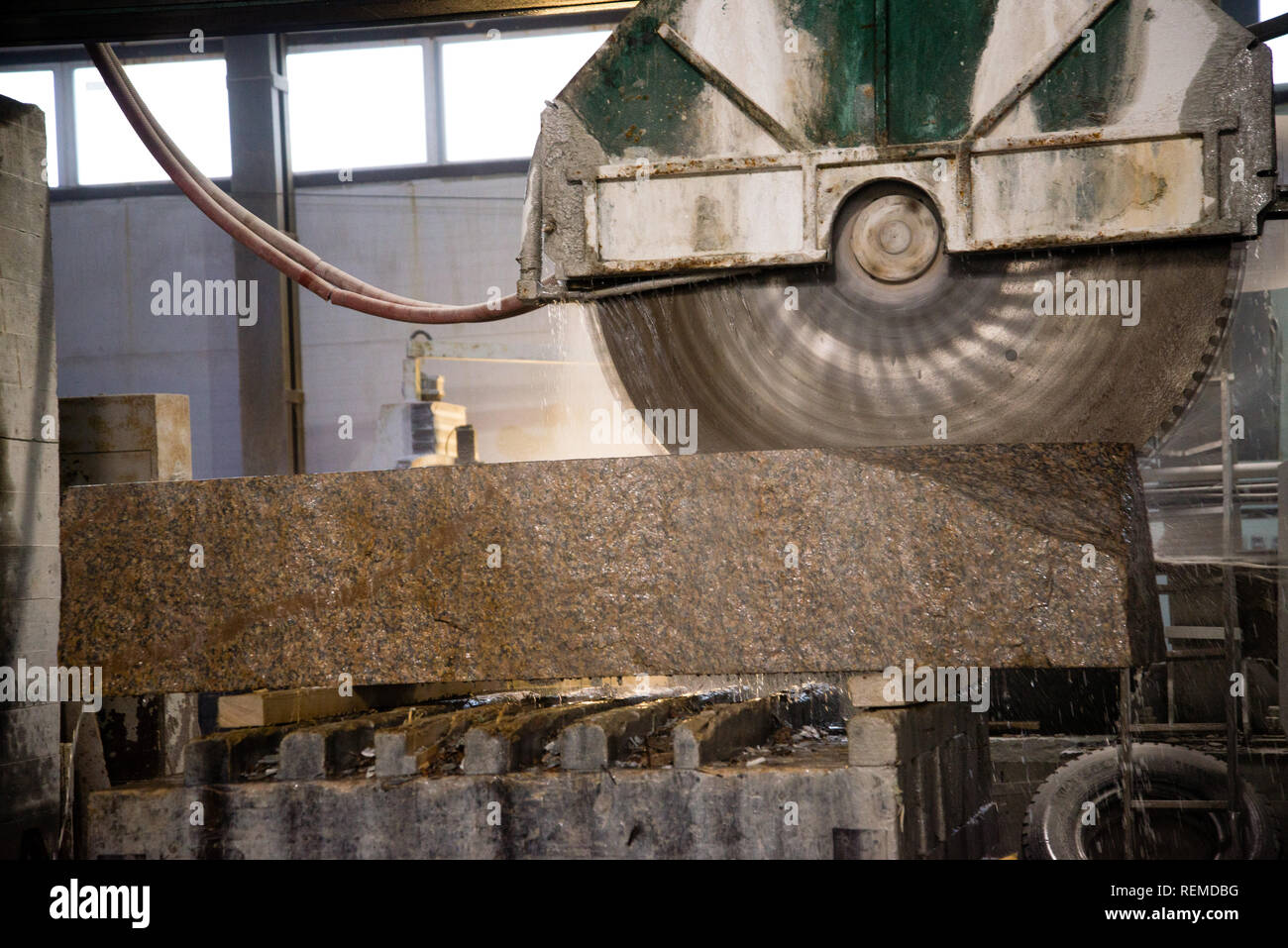 Granite processing in manufacturing. Cutting granite slab with a