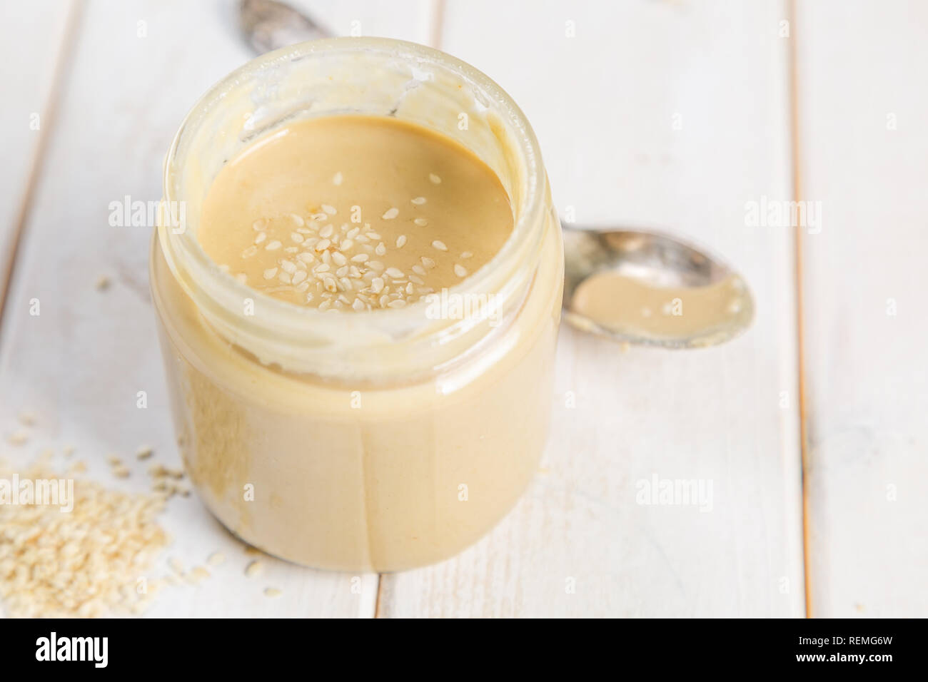 Sesame seeds butter in glass jar Stock Photo Alamy