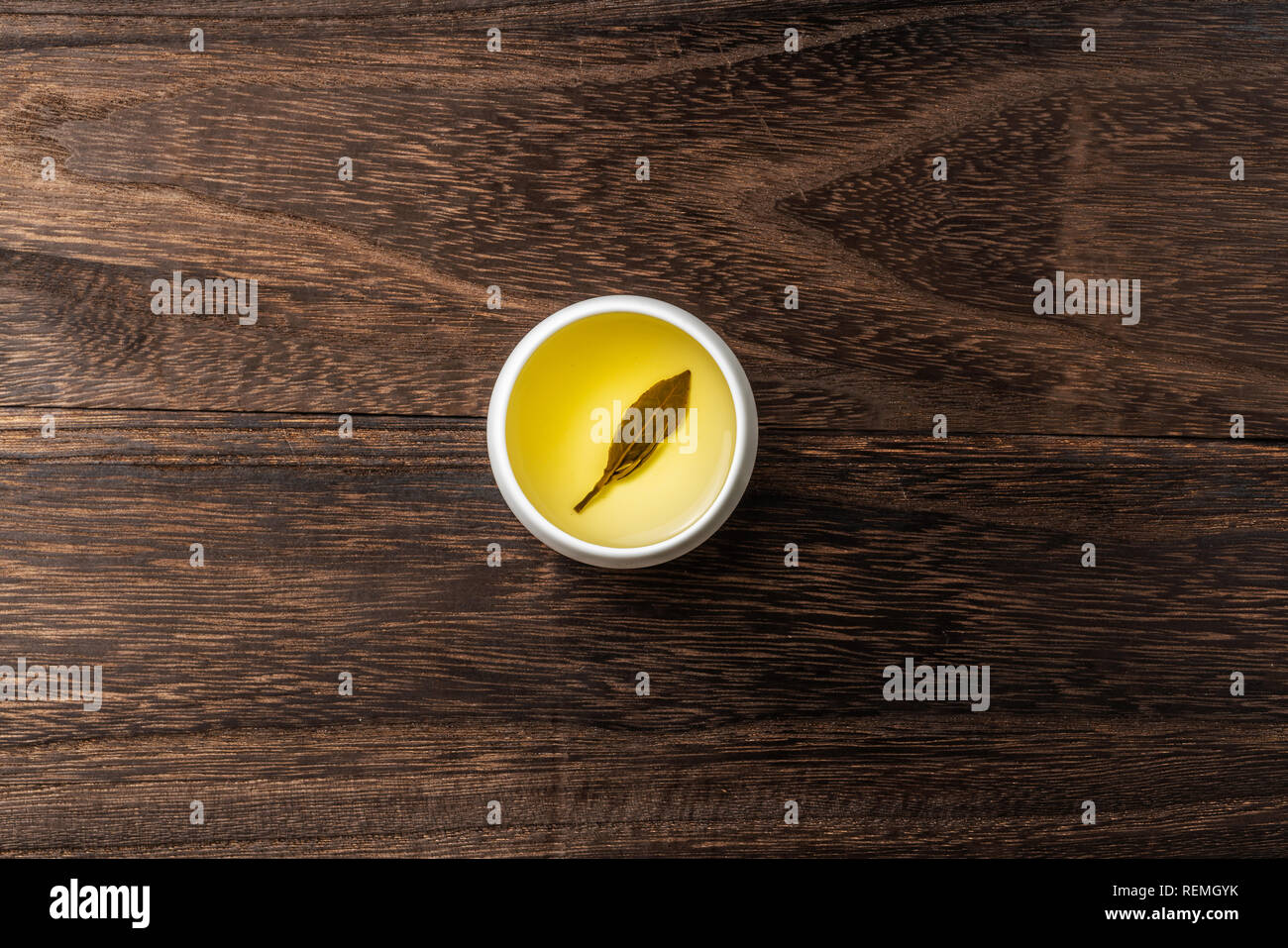 Asia culture and design concept - fresh taiwan oolong tea and cup on dark wood background Stock Photo