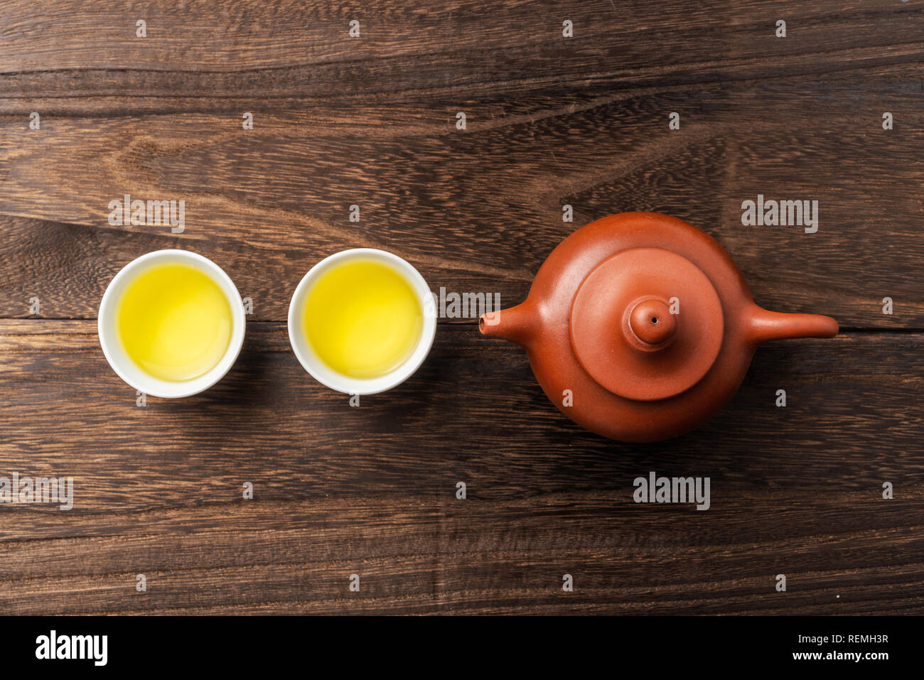 Asia culture and design concept - fresh taiwan oolong tea and teapot on dark wood background Stock Photo