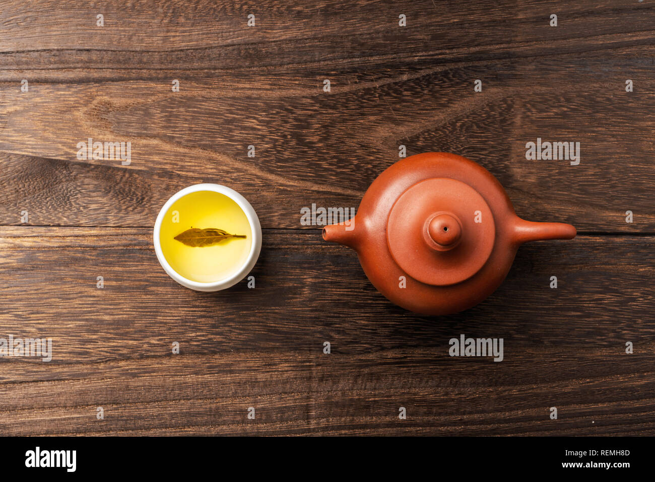 Asia culture and design concept - fresh taiwan oolong tea and teapot on dark wood background Stock Photo