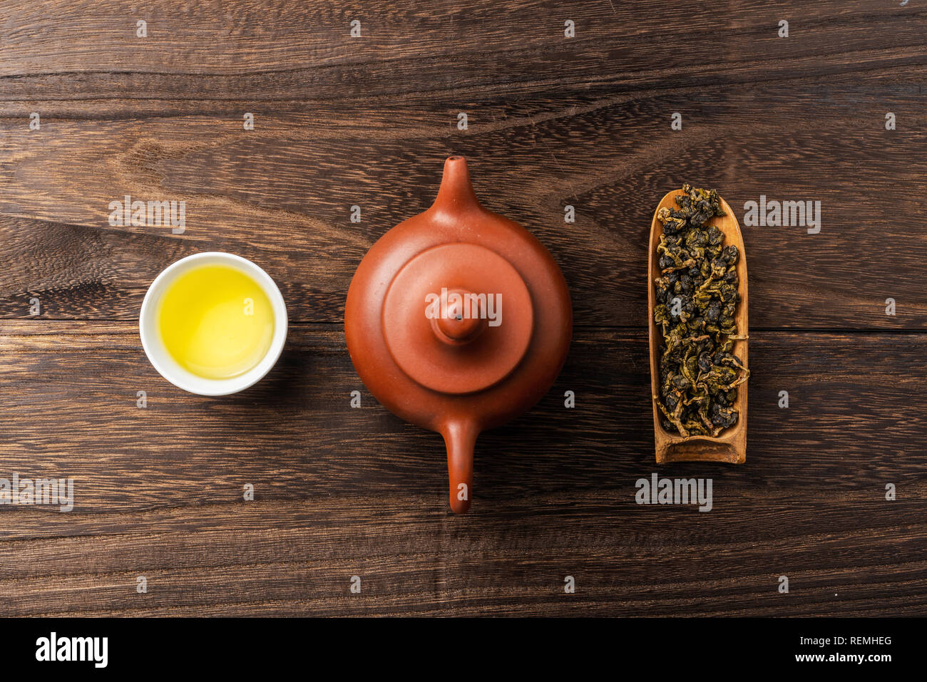 Asia culture and design concept - fresh taiwan oolong tea and teapot on dark wood background Stock Photo