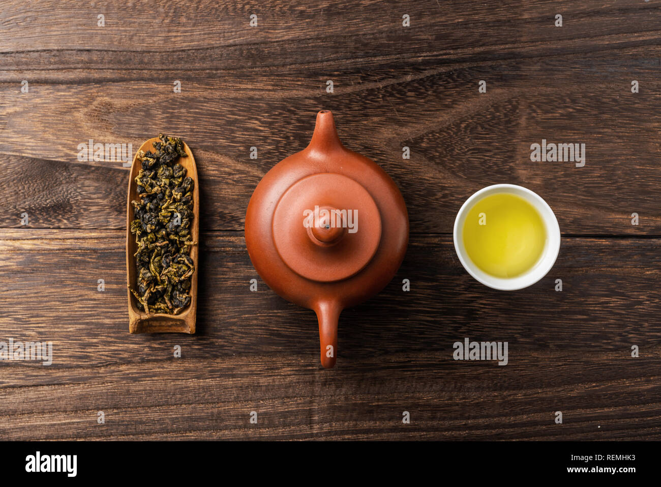 Asia culture and design concept - fresh taiwan oolong tea and teapot on dark wood background Stock Photo