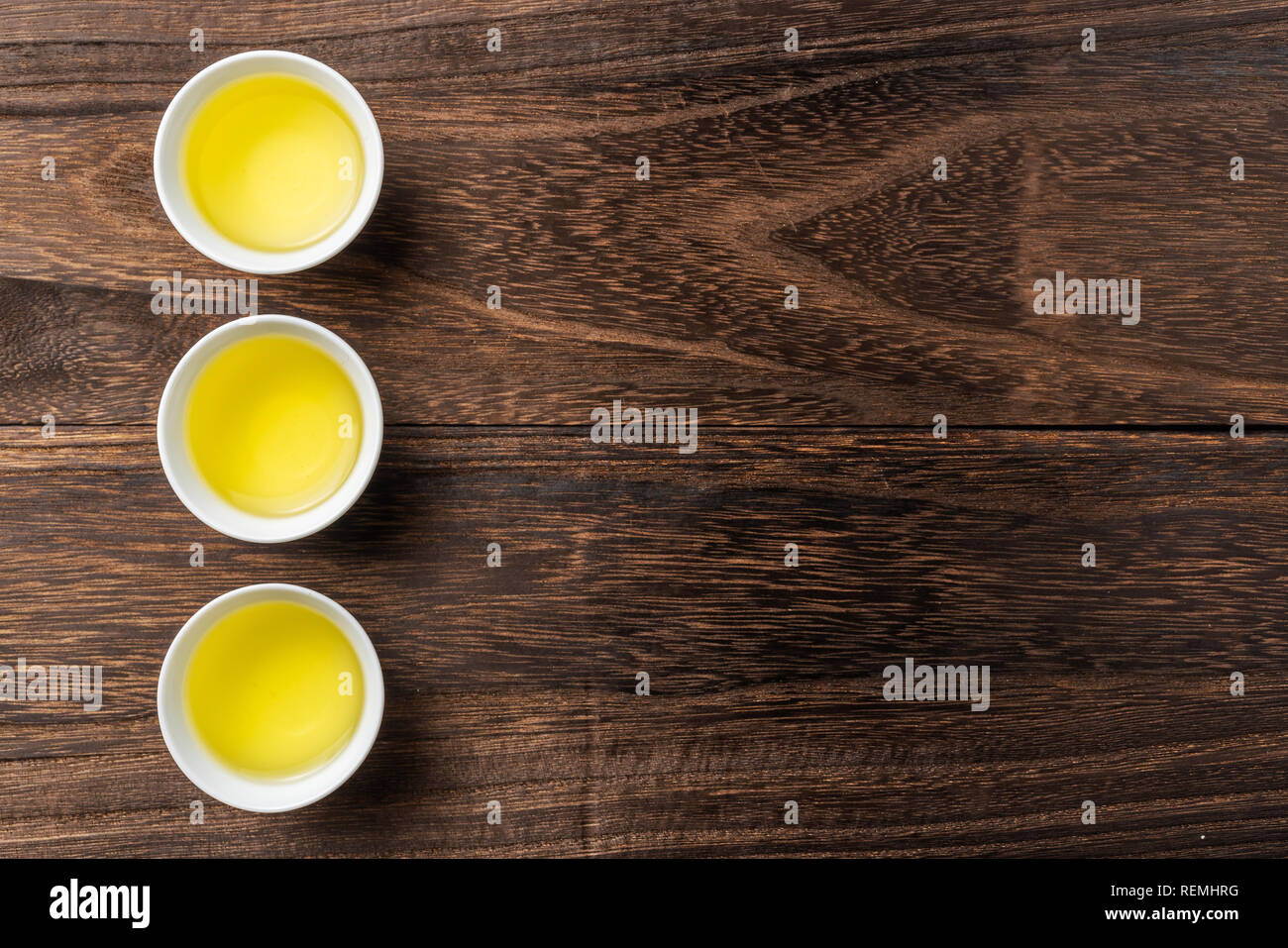 Asia culture and design concept - fresh taiwan oolong tea and cup on dark wood background Stock Photo