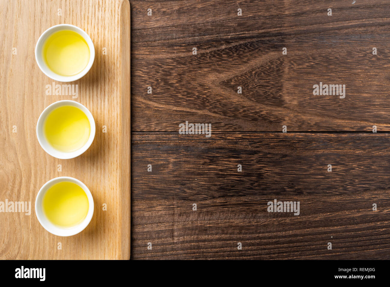 Asia culture and design concept - fresh taiwan oolong tea and cup on dark wood background Stock Photo