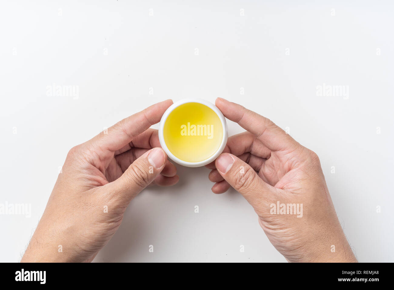 Asia culture and design concept - man's hand hold fresh taiwan oolong tea cup Stock Photo