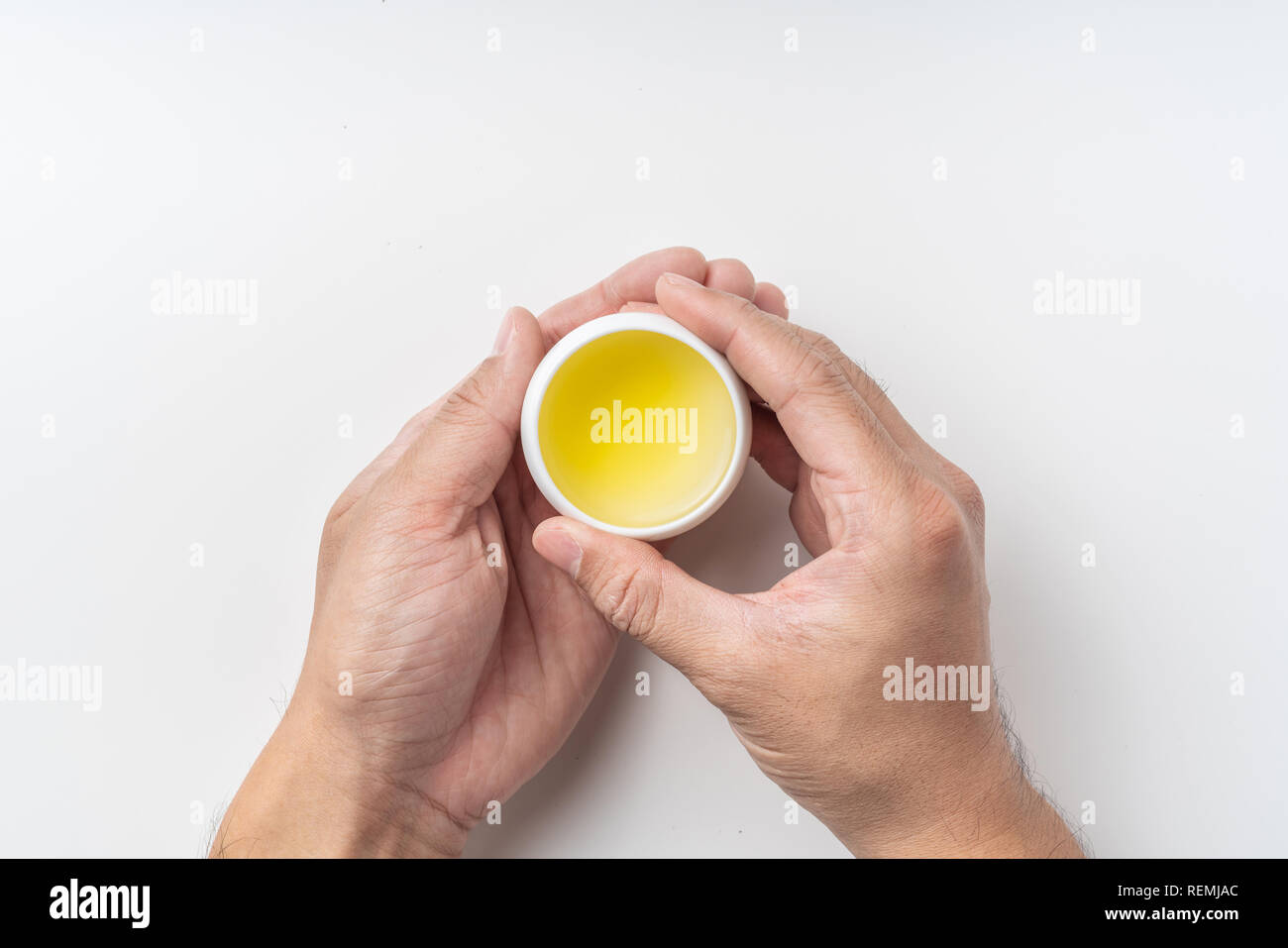 Asia culture and design concept - man's hand hold fresh taiwan oolong tea cup Stock Photo