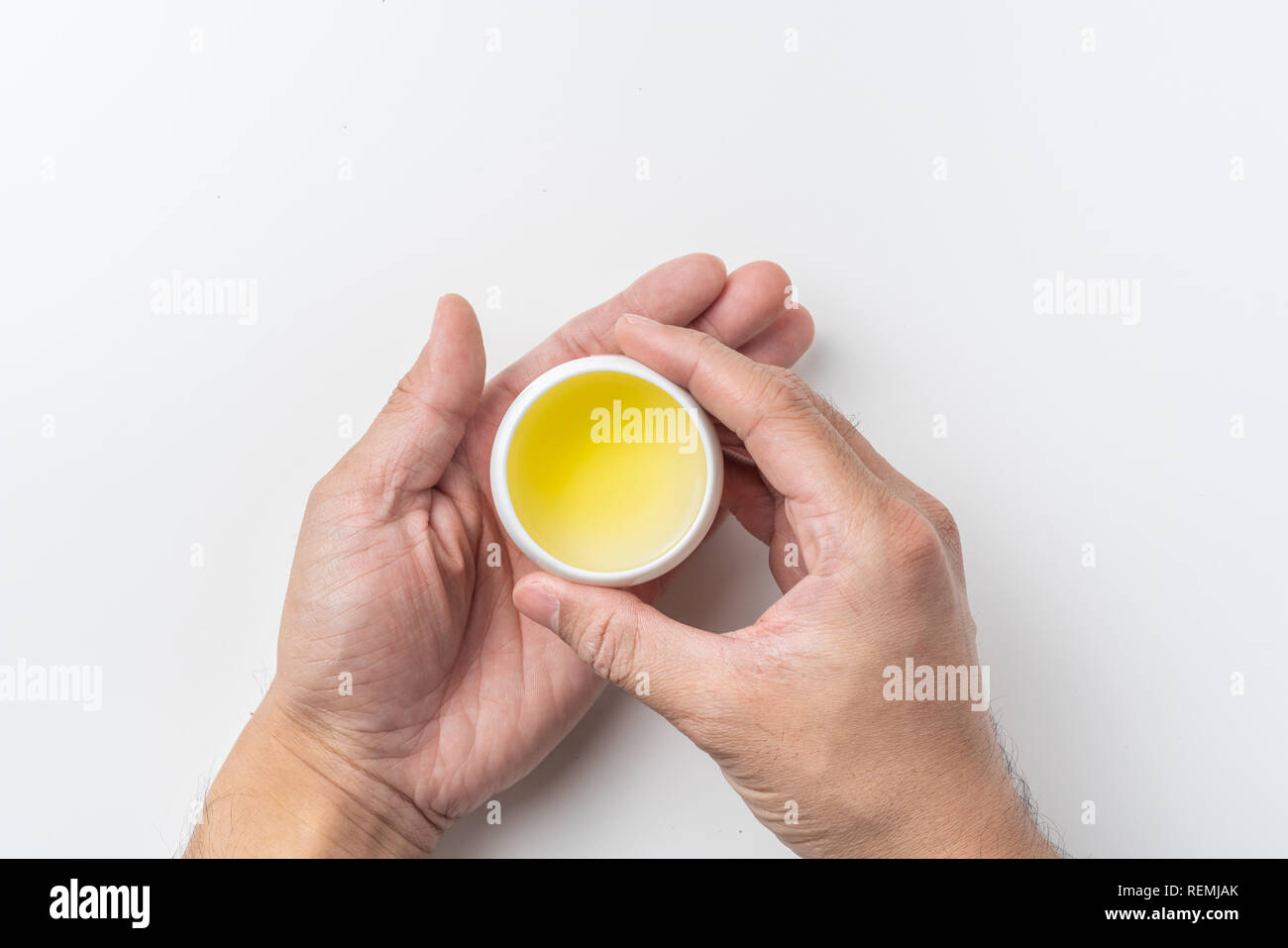 Asia culture and design concept - man's hand hold fresh taiwan oolong tea cup Stock Photo
