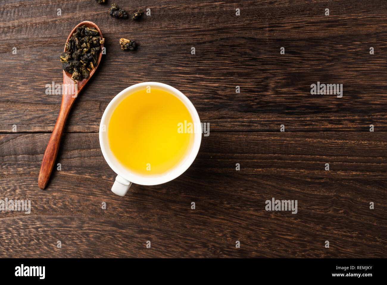 Asia culture and design concept - fresh taiwan oolong tea and cup on dark wood background Stock Photo
