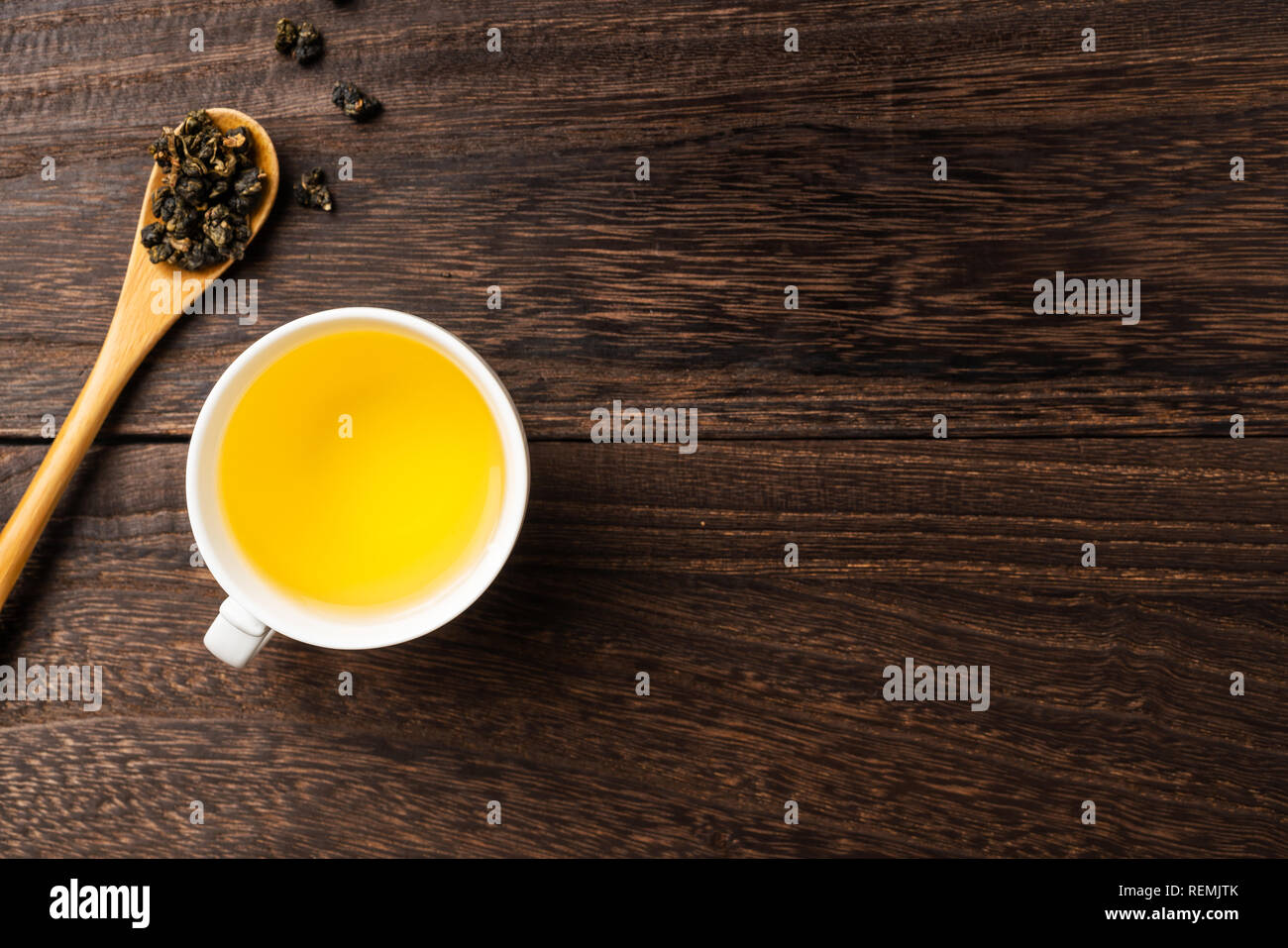 Asia culture and design concept - fresh taiwan oolong tea and cup on dark wood background Stock Photo