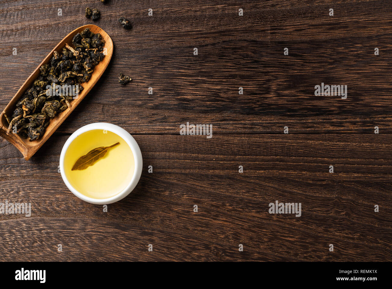 Asia culture and design concept - fresh taiwan oolong tea and cup on dark wood background Stock Photo