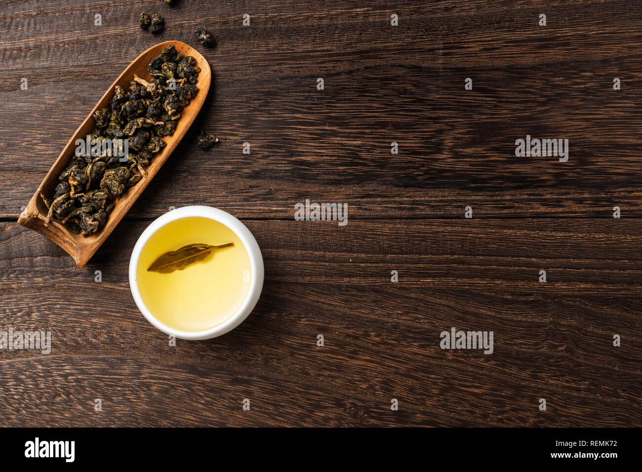 Asia culture and design concept - fresh taiwan oolong tea and cup on dark wood background Stock Photo