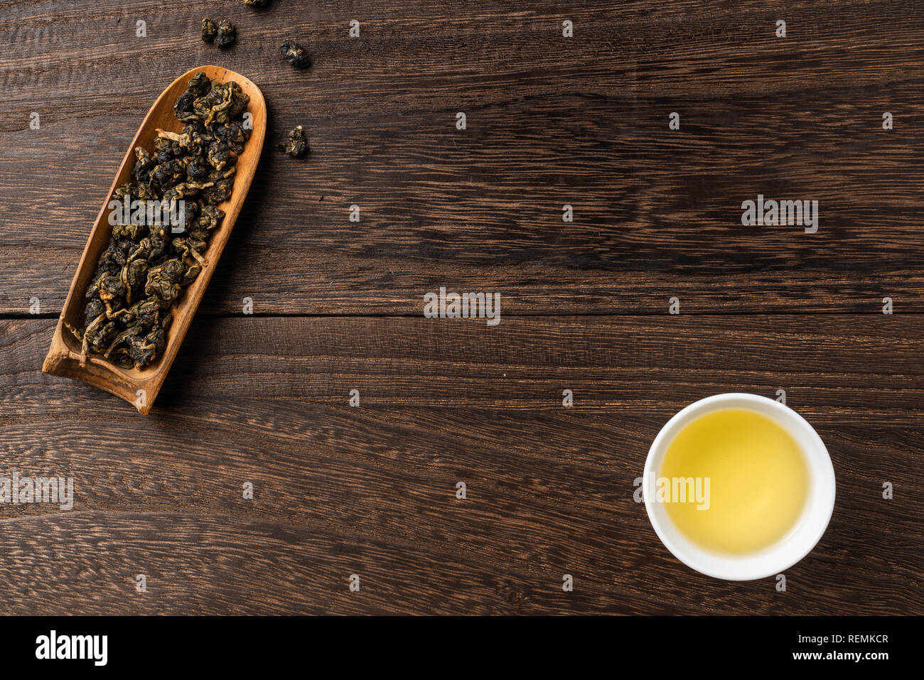 Asia culture and design concept - fresh taiwan oolong tea and cup on dark wood background Stock Photo