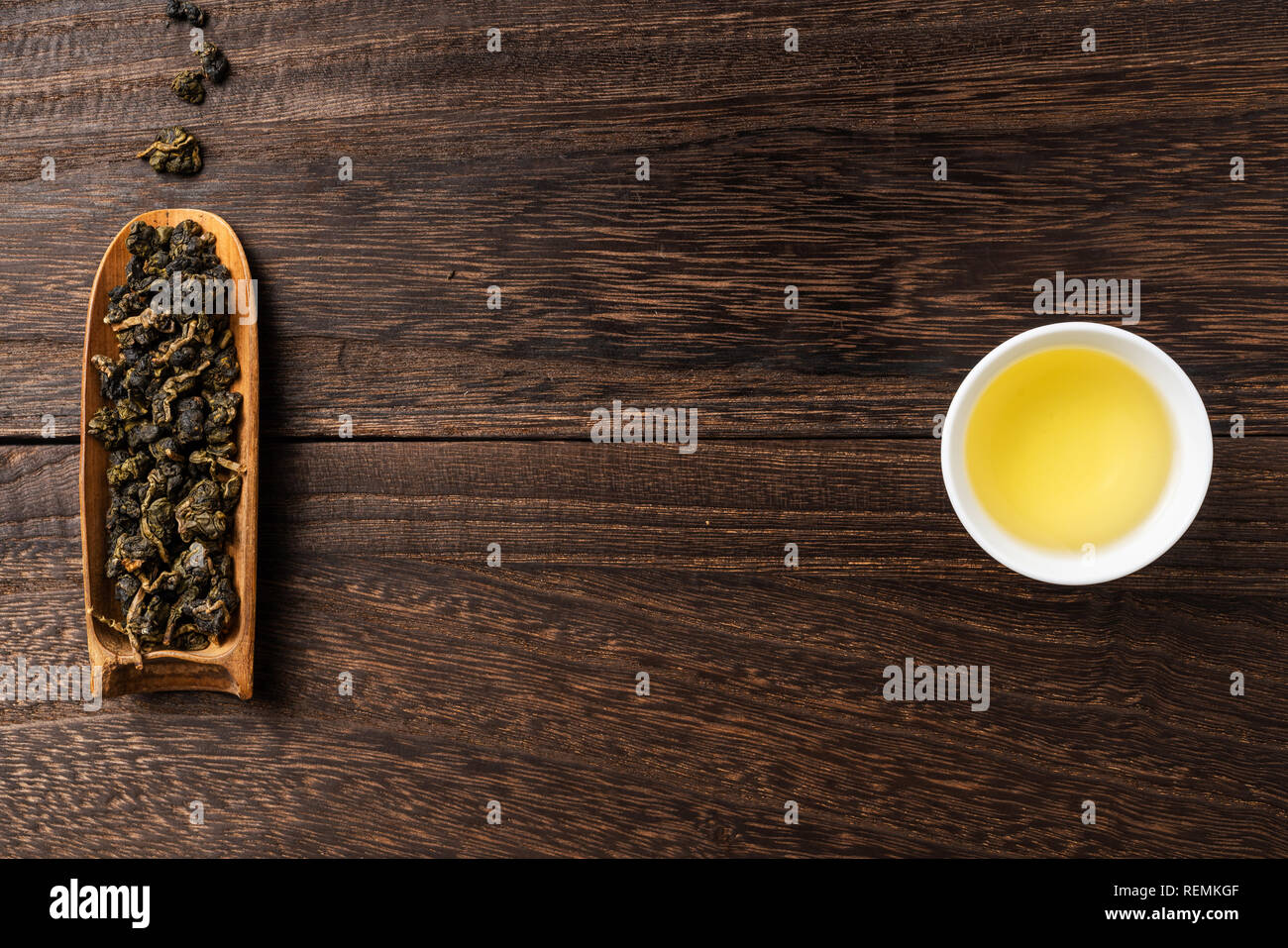 Asia culture and design concept - fresh taiwan oolong tea and cup on dark wood background Stock Photo
