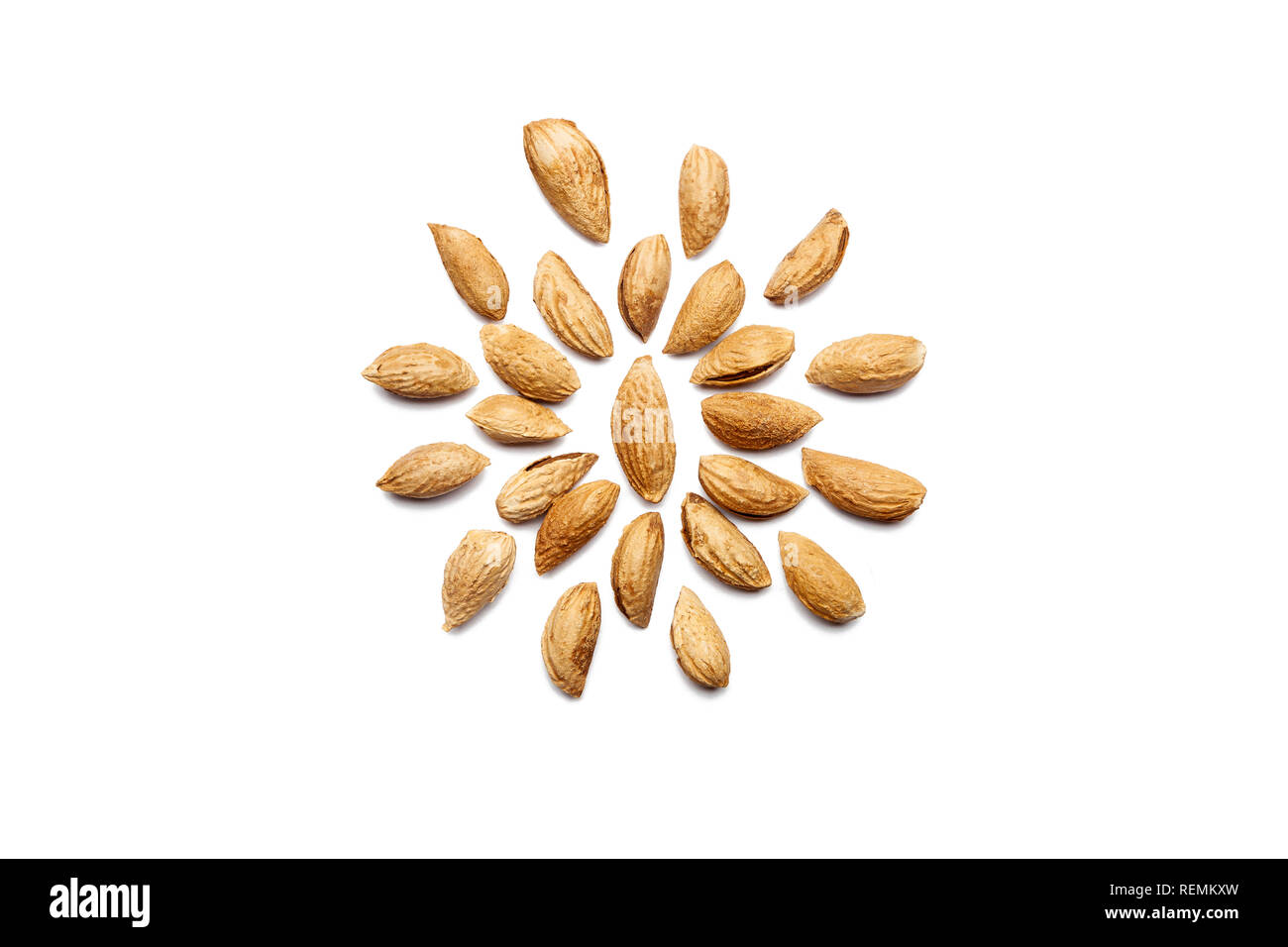 Pattern of Nuts - peeled almonds Badam on a white background in the form of a circle. Concepts about decoration, healthy eating and food background. Stock Photo