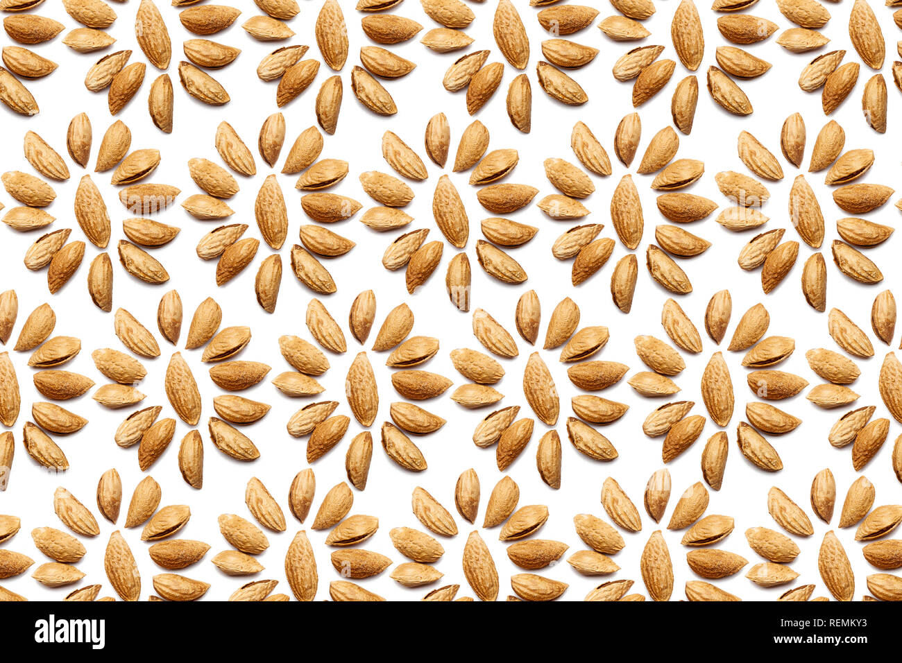 Pattern of Nuts - peeled almonds Badam on a white background in the form of a circle. Concepts about decoration, healthy eating and food background. Stock Photo