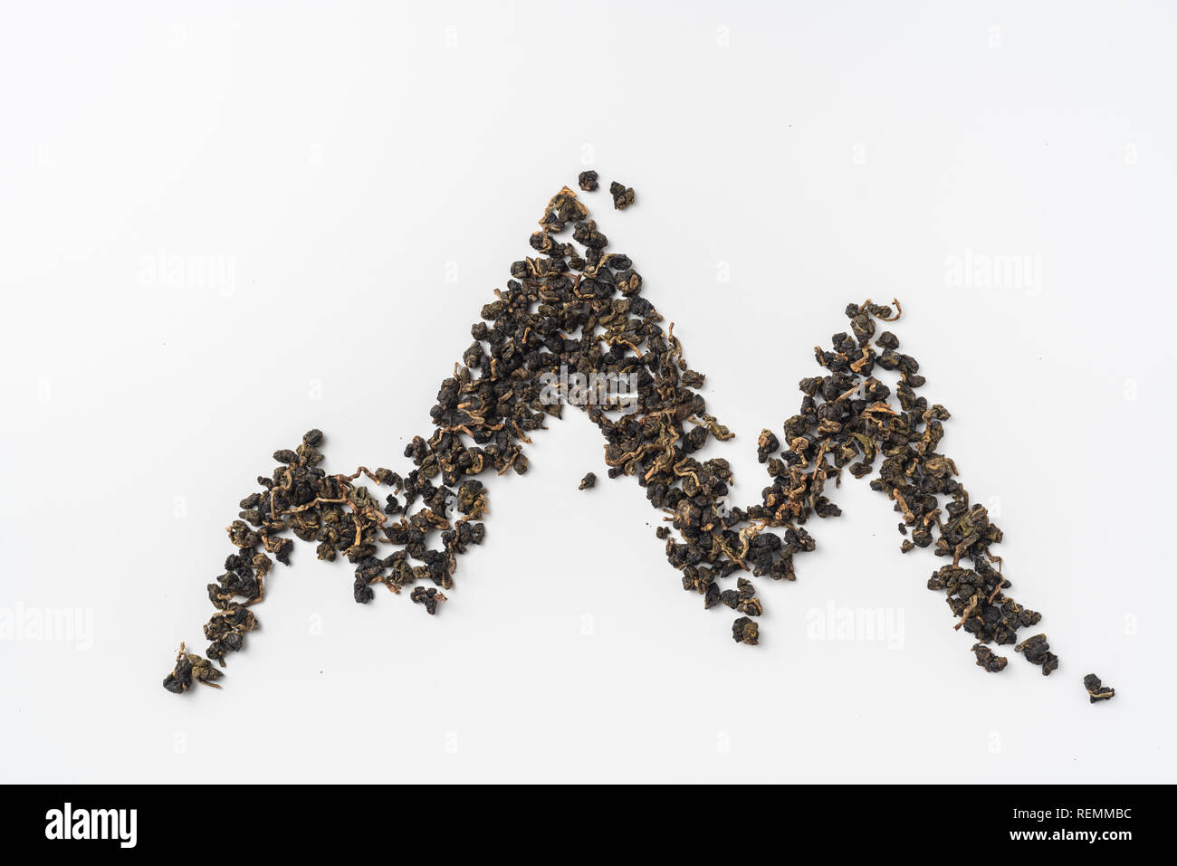 Asia culture and design concept - fresh taiwan oolong tea and cup with mountain shape made by dry tea dust Stock Photo