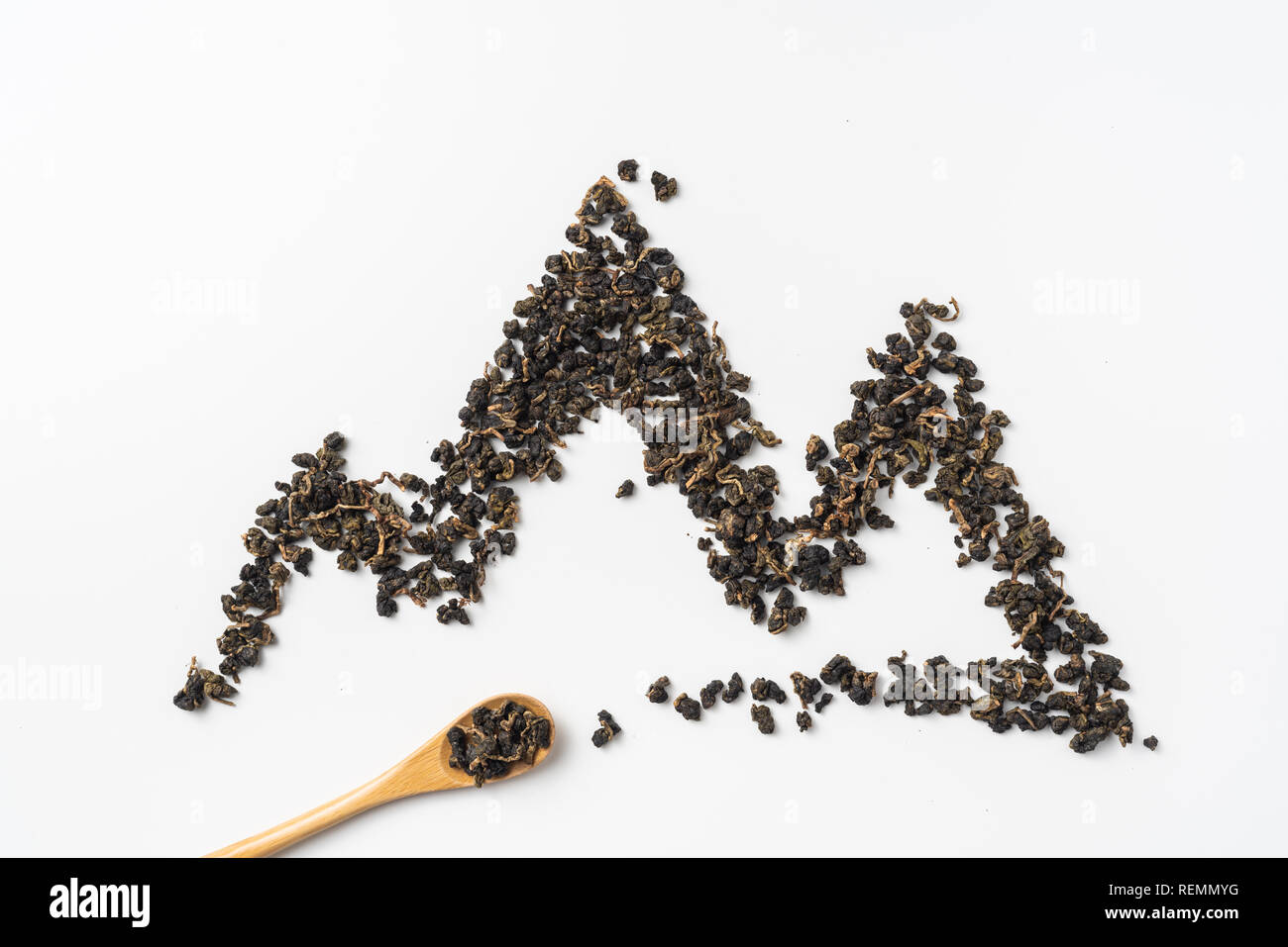 Asia culture and design concept - fresh taiwan oolong tea and cup with mountain shape made by dry tea dust Stock Photo