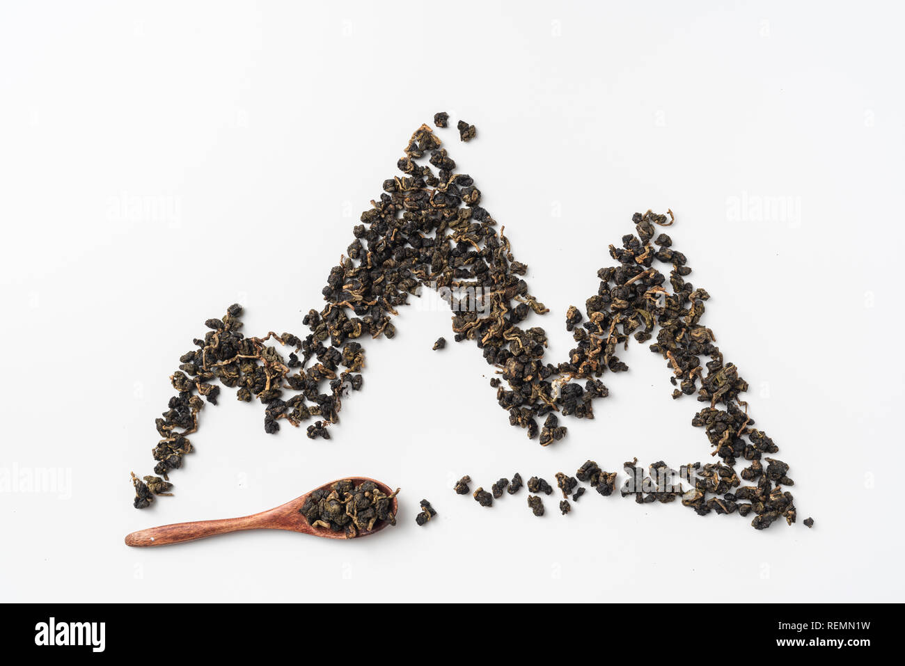 Asia culture and design concept - fresh taiwan oolong tea and cup with mountain shape made by dry tea dust Stock Photo
