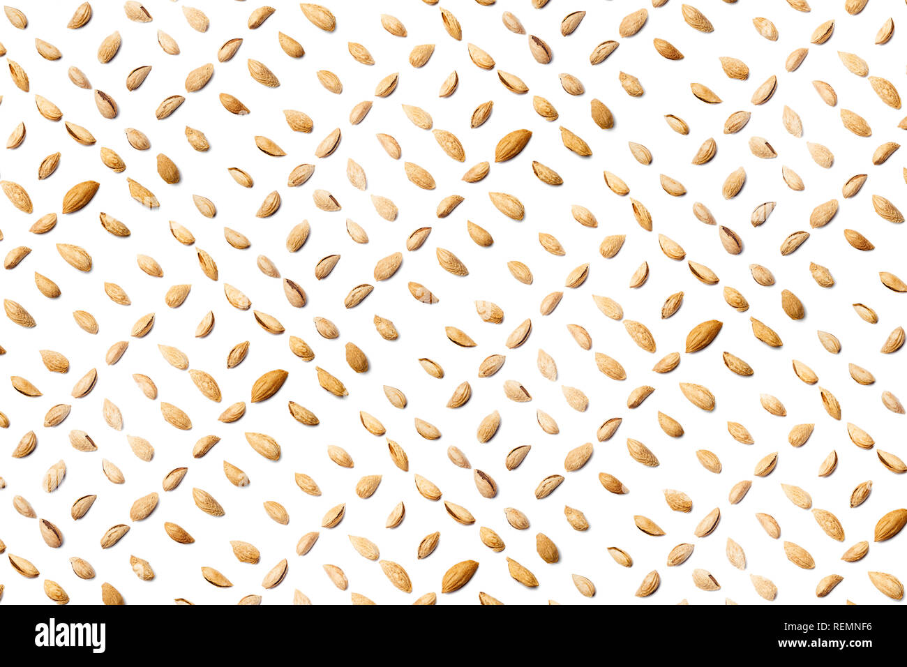 A collection of peeled almonds Badam  lie in straight rows along dioganals on an isolated white background. with clipping path. peeled almonds Badam   Stock Photo