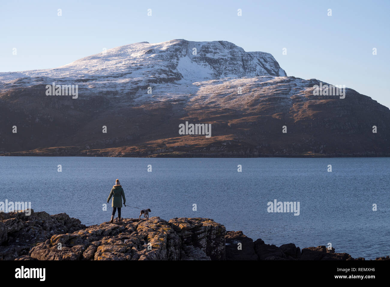 Walking the dog at Rhue looking towards Beinn Ghobhlach on Loch Broom, Wester Ross, Scotland Stock Photo