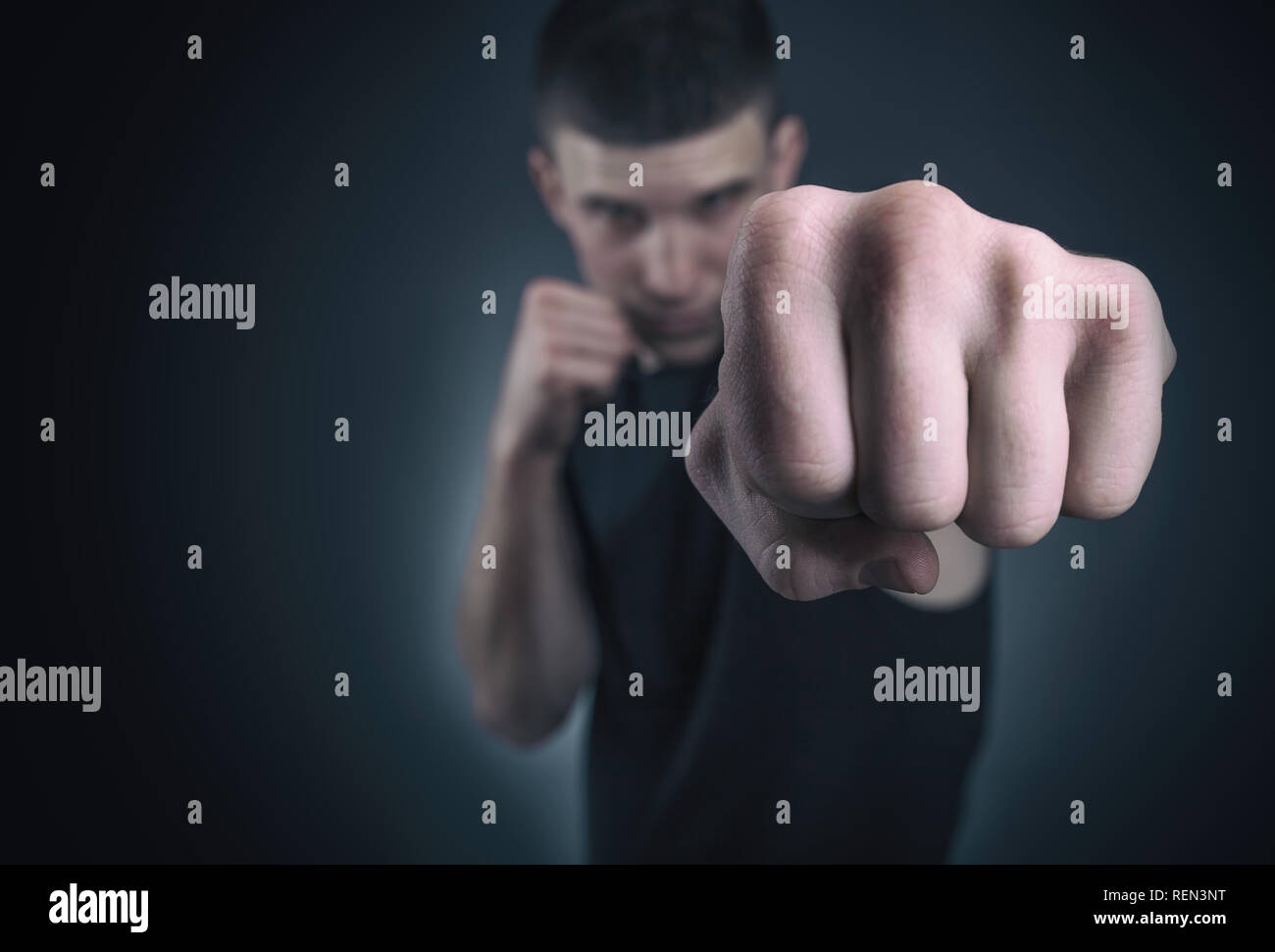Handsome athletic man in boxing stand. Focus on fist Stock Photo