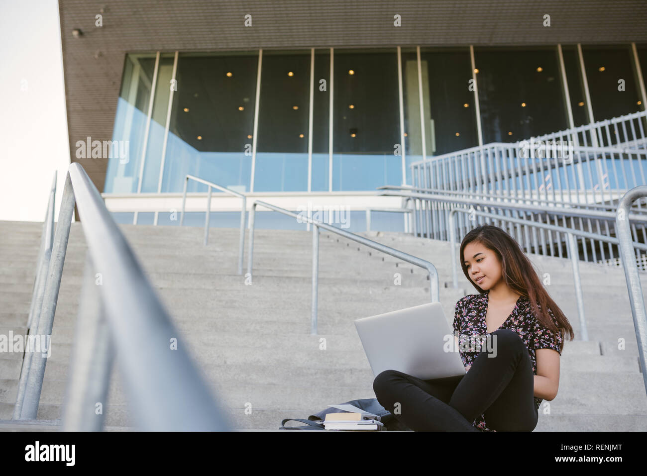 Young Asian college student using a laptop on campus Stock Photo