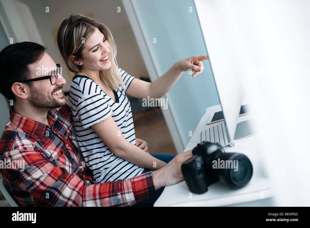 Young attractive designers working on project together Stock Photo