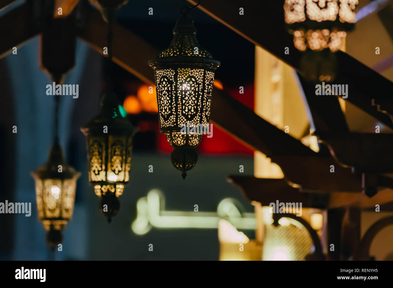 Arab street lanterns illuminate in the night city of Dubai in the