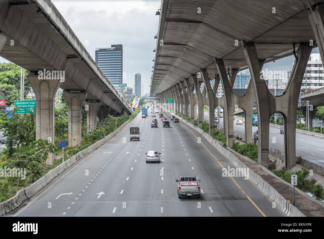 Bangkok, Thailand - July 30, 2018: Bang Na - Trat Road (National Highway route 34) with concrete pillars of a toll road (on right). Stock Photo