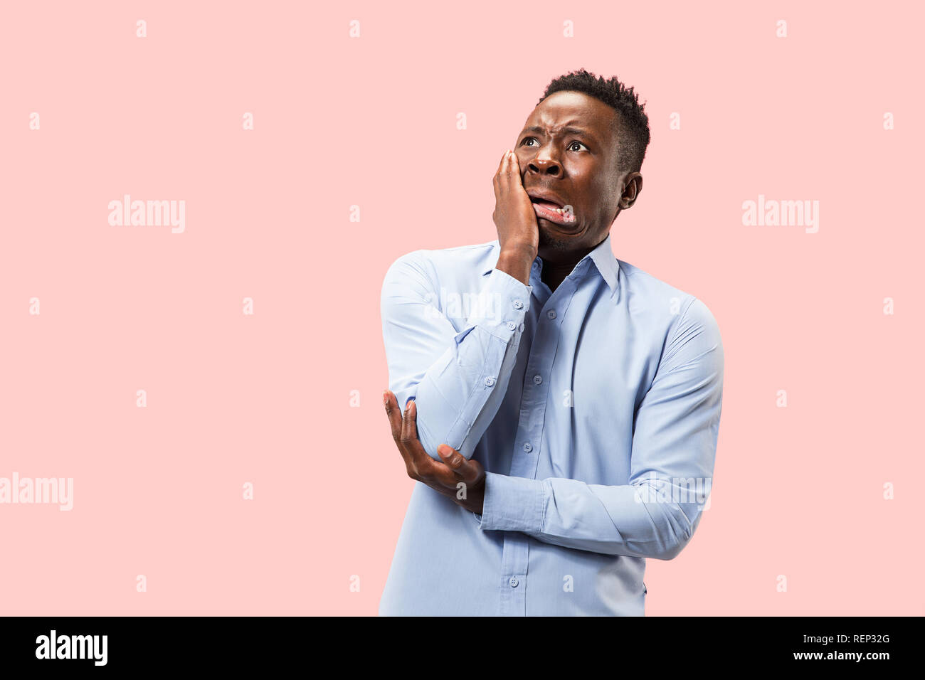 Young afro man with a surprised unhappy failure expression bet slip on ...