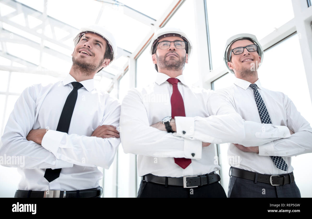 three architects standing in an empty office Stock Photo