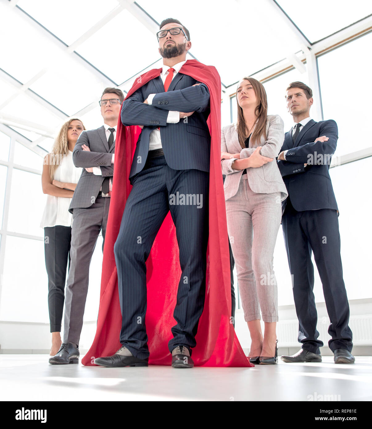 leader in the red cloak and the business team standing together Stock ...