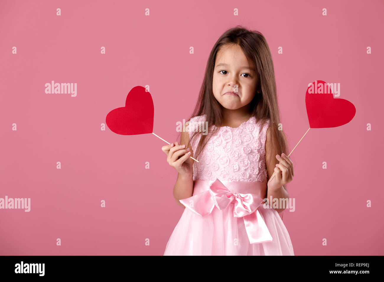 cute little girl in a pink dress holding a paper heart Stock Photo - Alamy