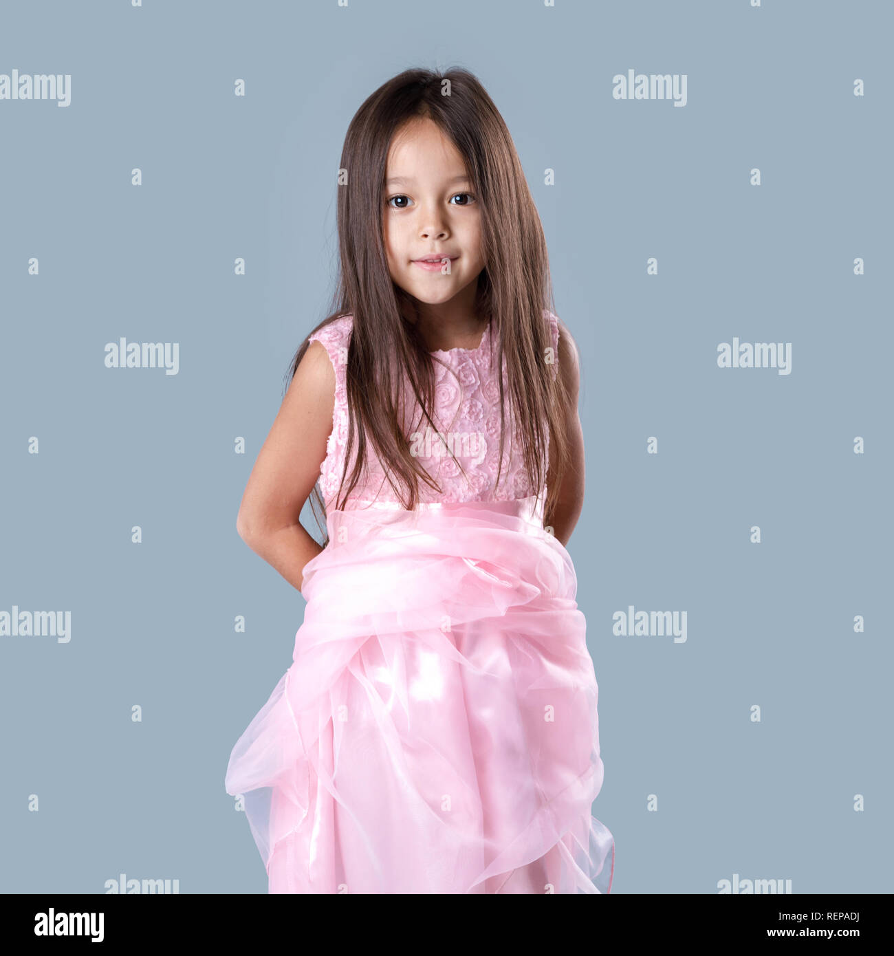 cute little girl in pink princess dress on gray background Stock Photo ...