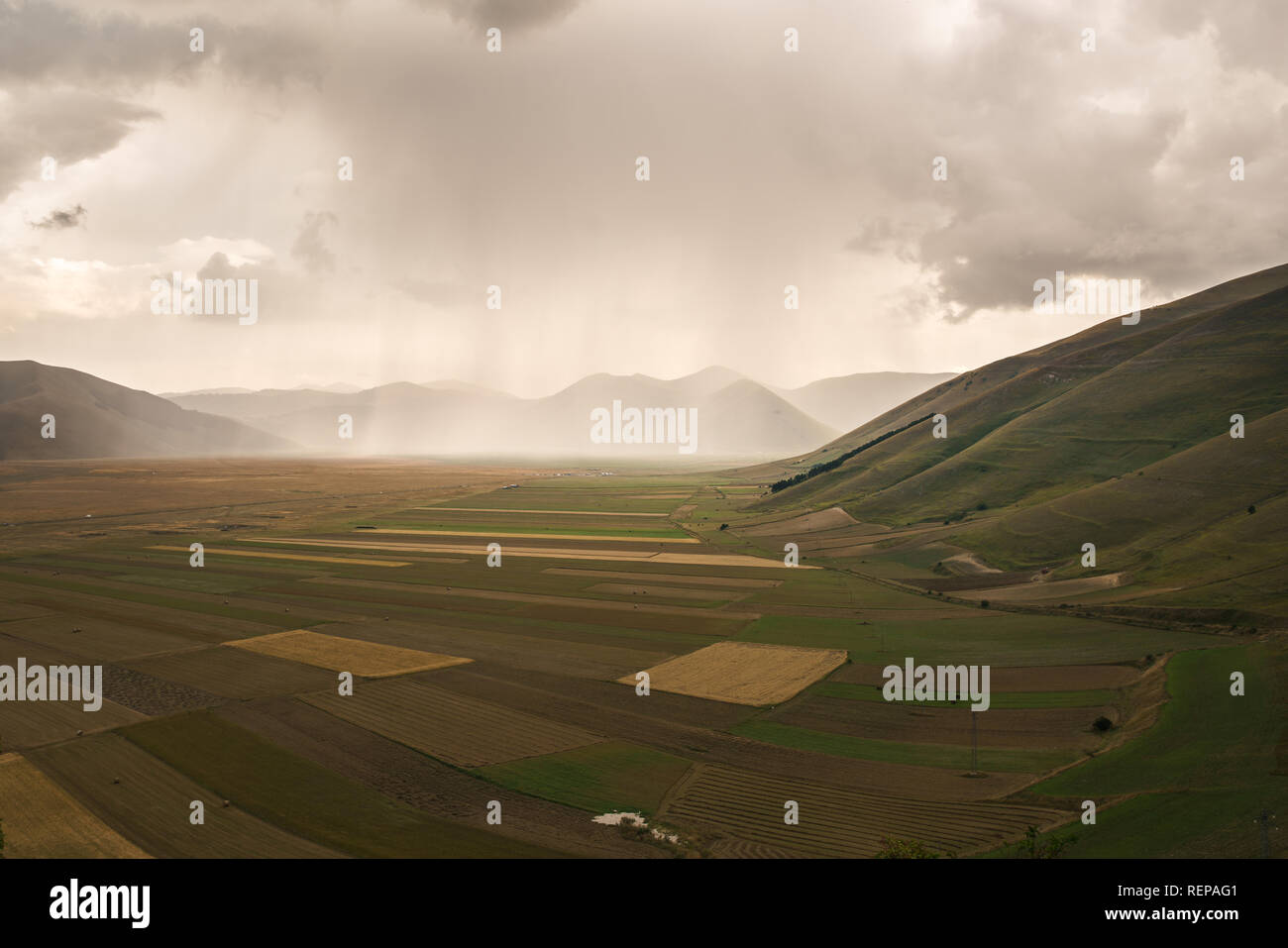 View from Castelluccio during a big coming Storm: incredible agriculture architecture in a wonderfull valley in Monti Sibillini National Park. Stock Photo