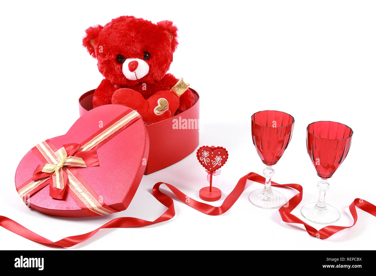 Valentine's Day concept. Red teddy bear in heart shaped gift box with ...