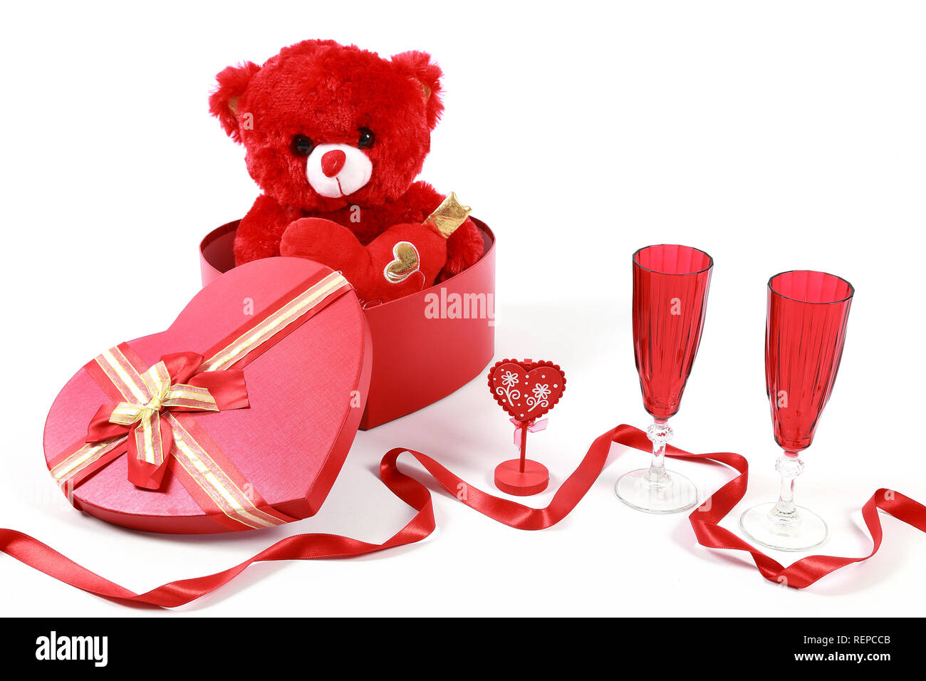 Valentine's Day concept. Red teddy bear in heart shaped gift box with ...