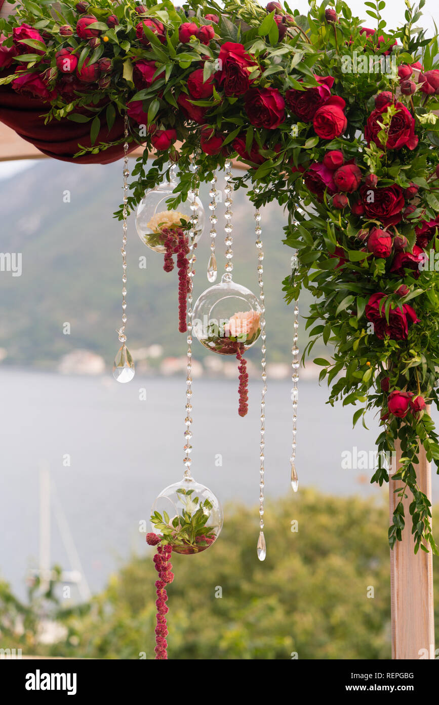 Arch Decorated With Fresh Flowers In Dark Red Tones For The
