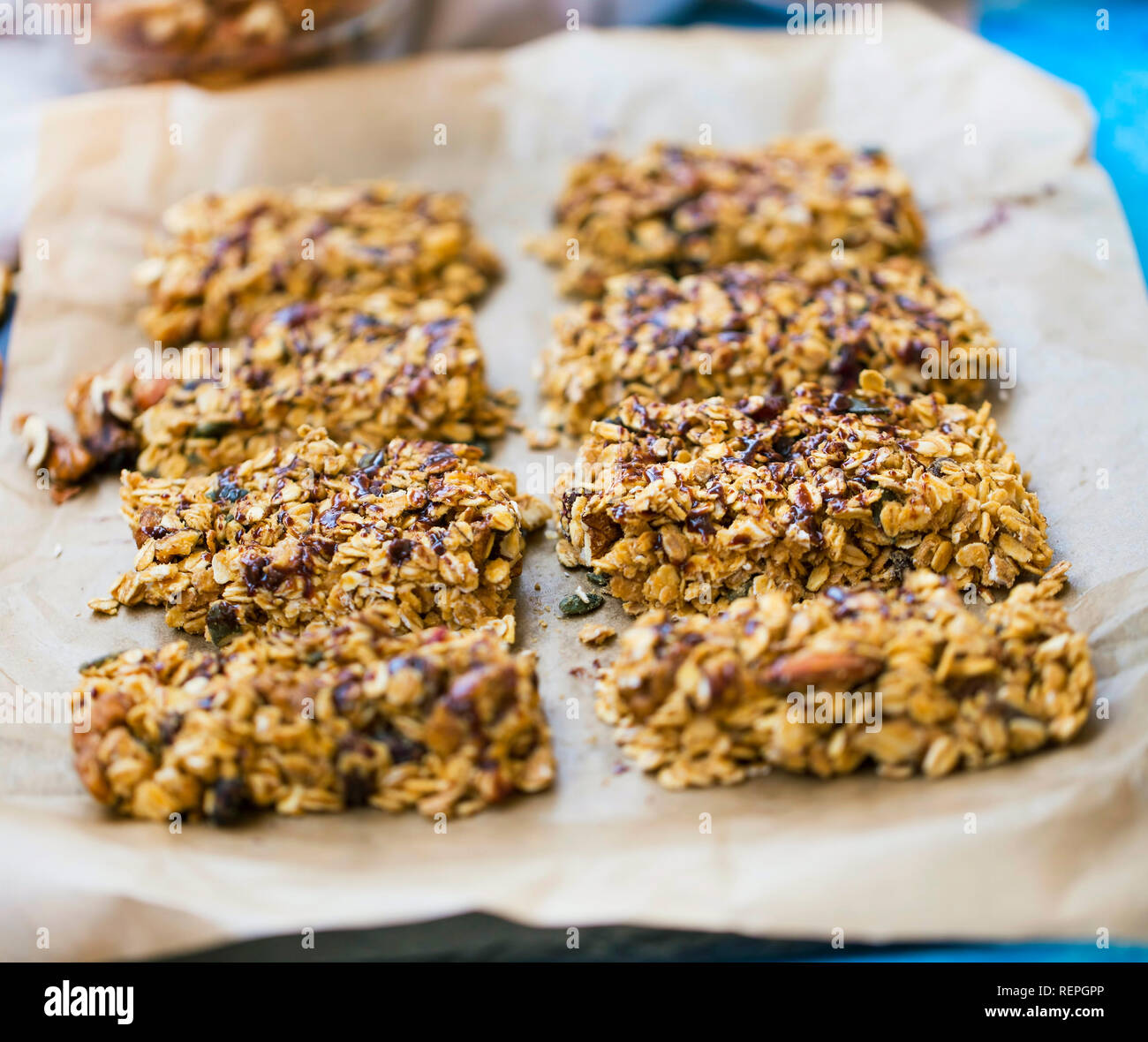 Homemade granola bars with oats, nuts, seeds and chocolate syrup