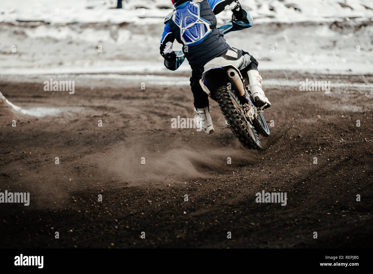 motorcycle racer enduro motocross riding on winter track Stock Photo