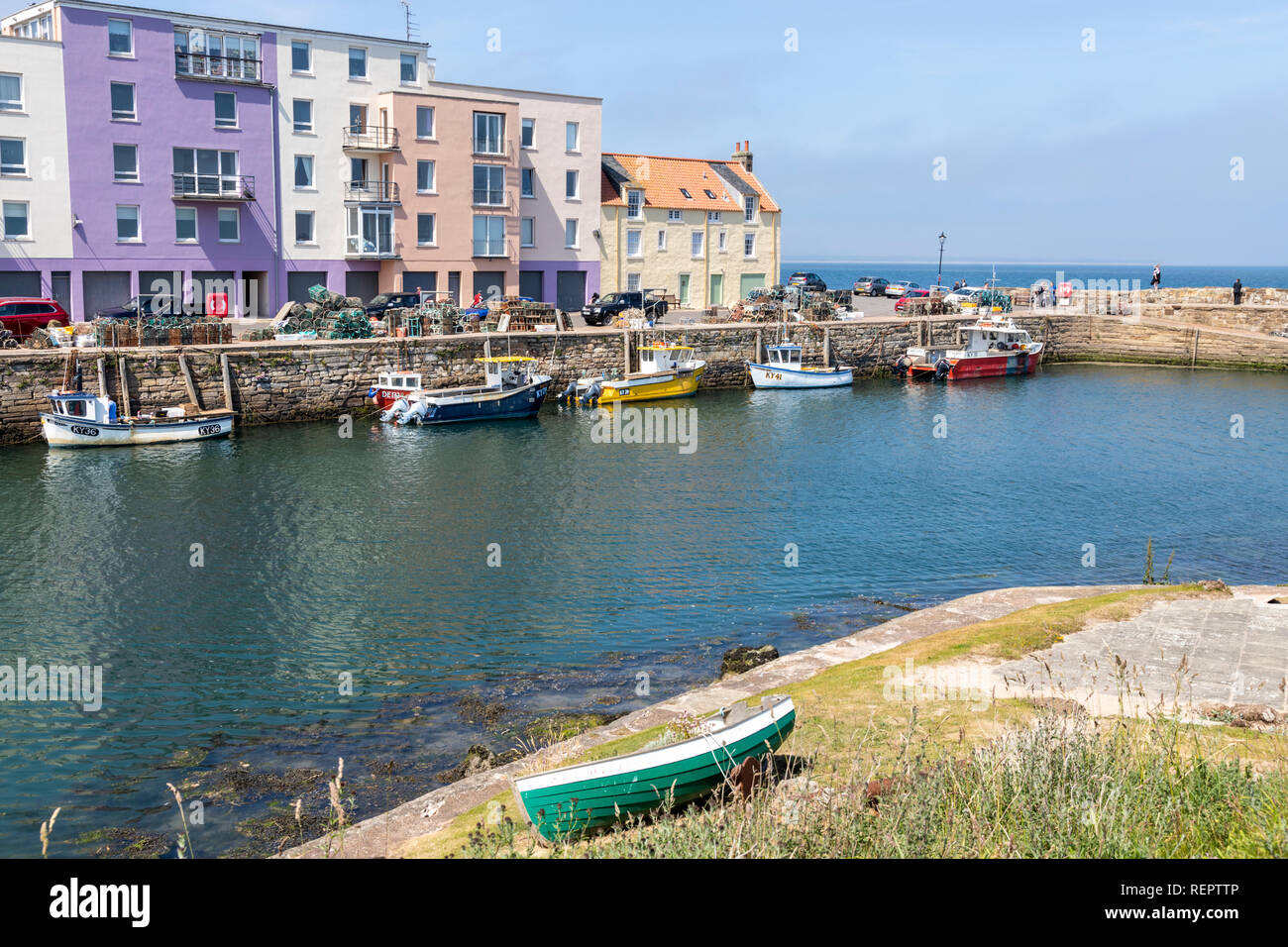 Fishing boats in the harbour at high tide at St Andrews, Fife, Scotland UK Stock Photo