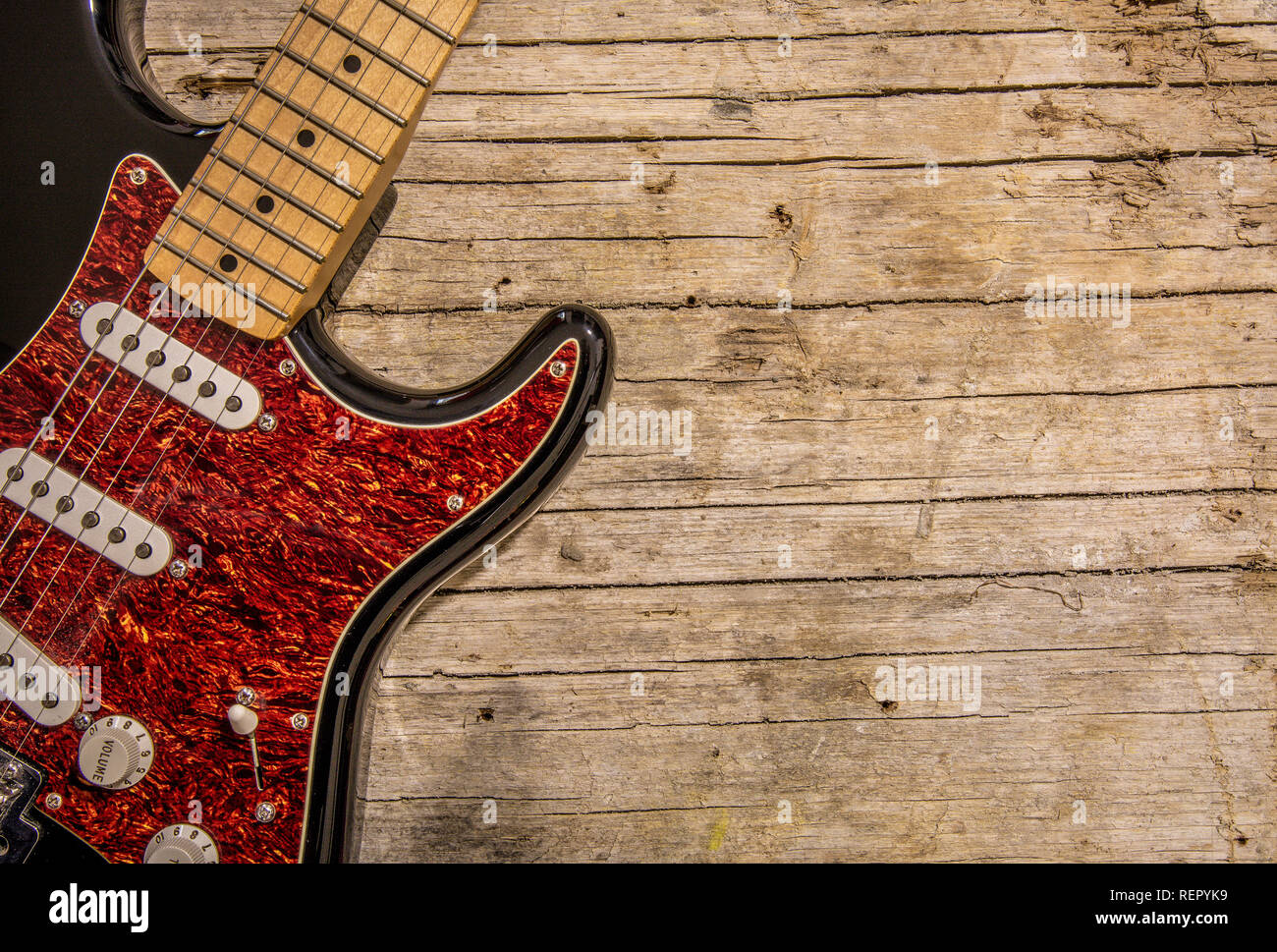 Close-up of electric guitar lying on vintage wood background, with copy space Stock Photo