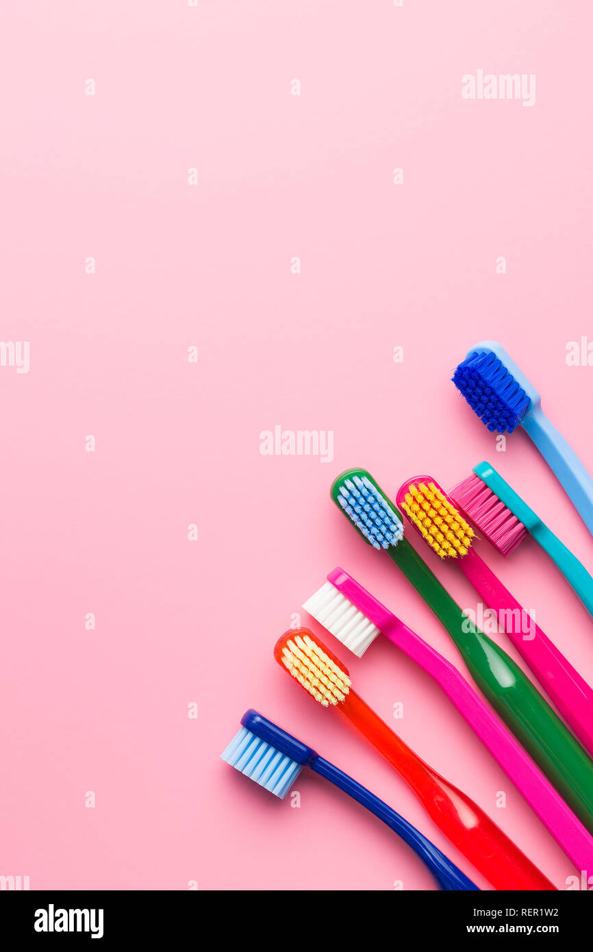 Colorful toothbrushes on pink background. Top view Stock Photo - Alamy