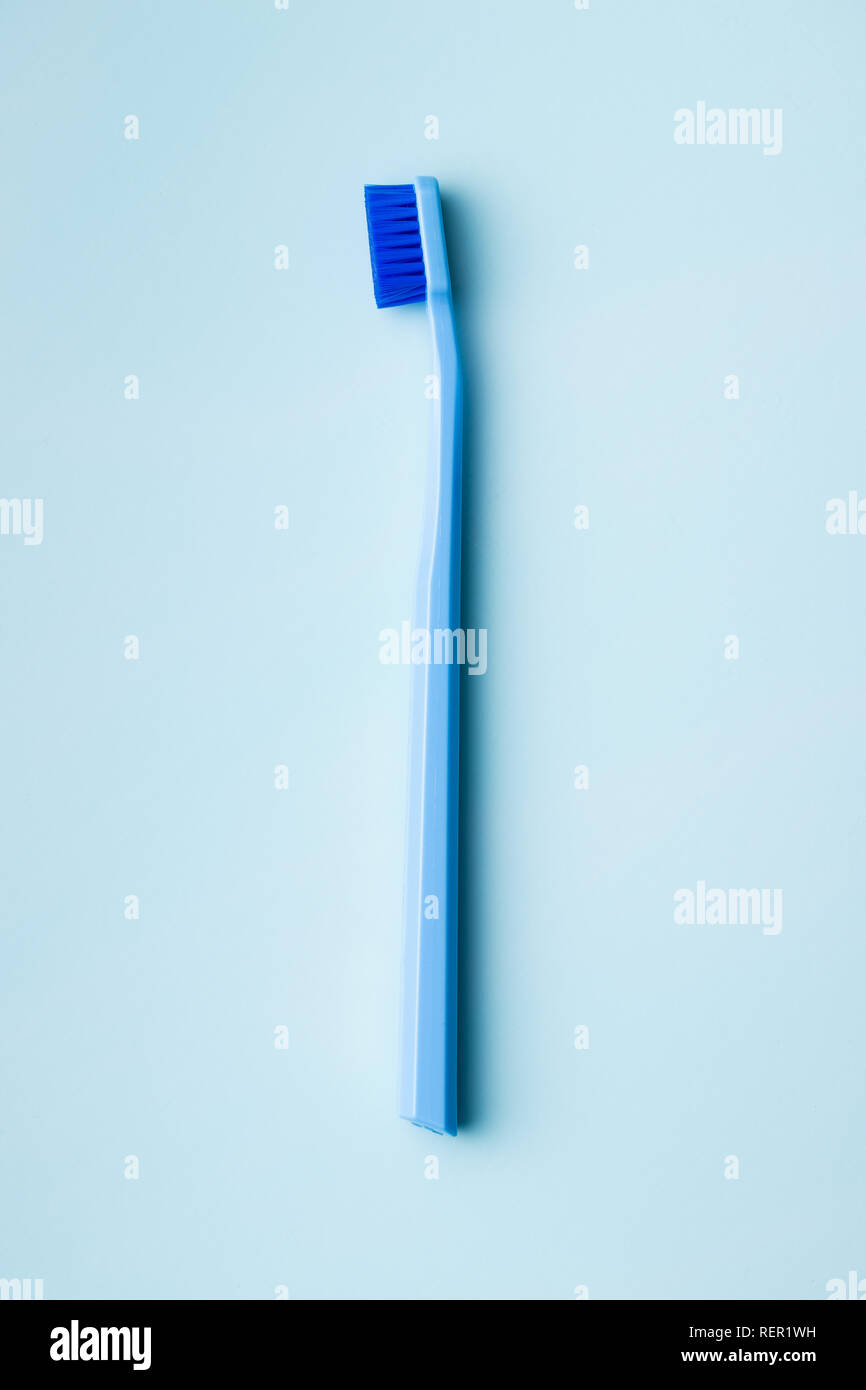 Colorful toothbrush on blue background. Top view Stock Photo - Alamy