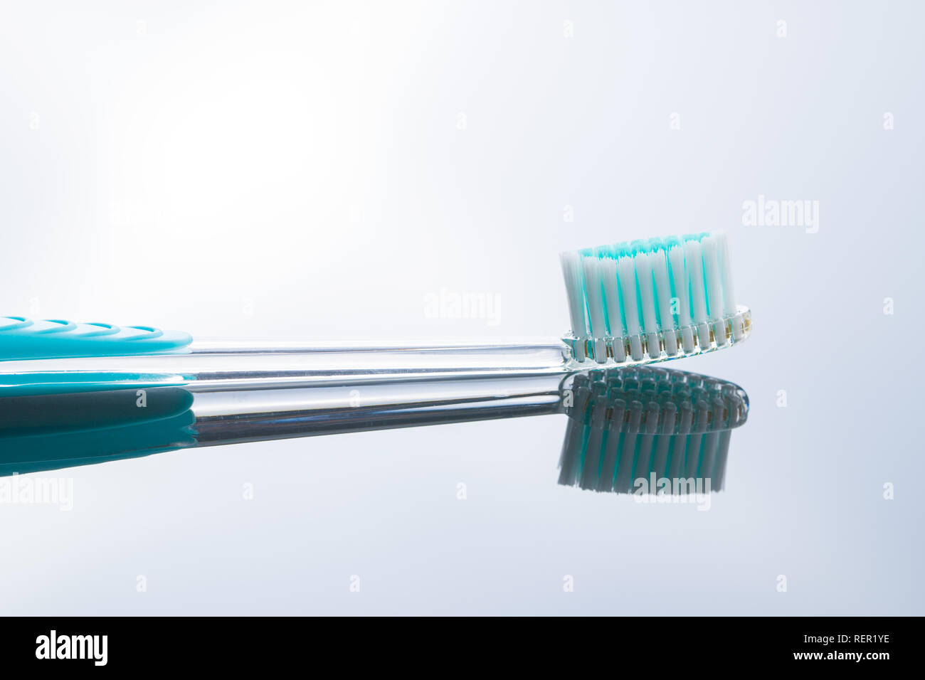 Colorful toothbrush on mirror background Stock Photo - Alamy