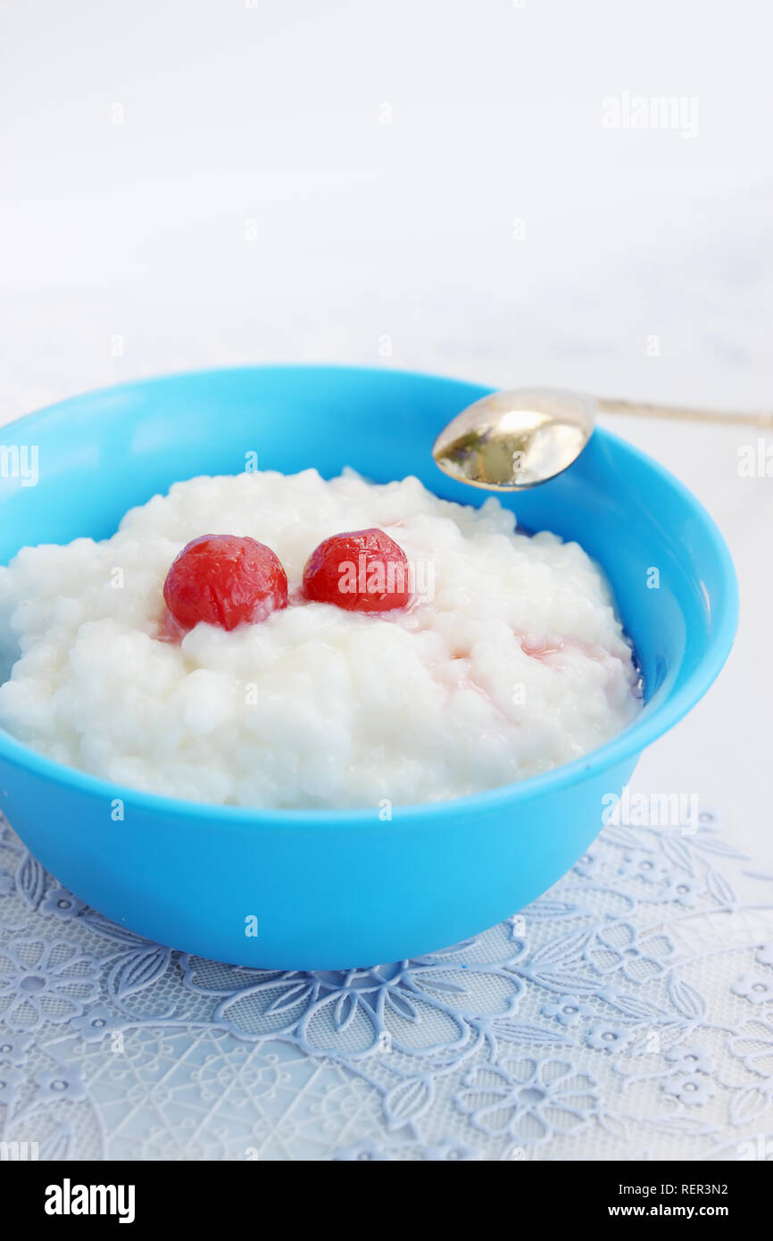 Rice porridge with milk canning cherry, dessert Stock Photo
