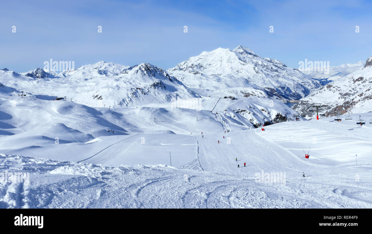Downhill skiing, snowboarding slopes, off piste trails, in French winter resort of Val d’Isere, Alps , with panorama of mountain snowy peaks and valle Stock Photo